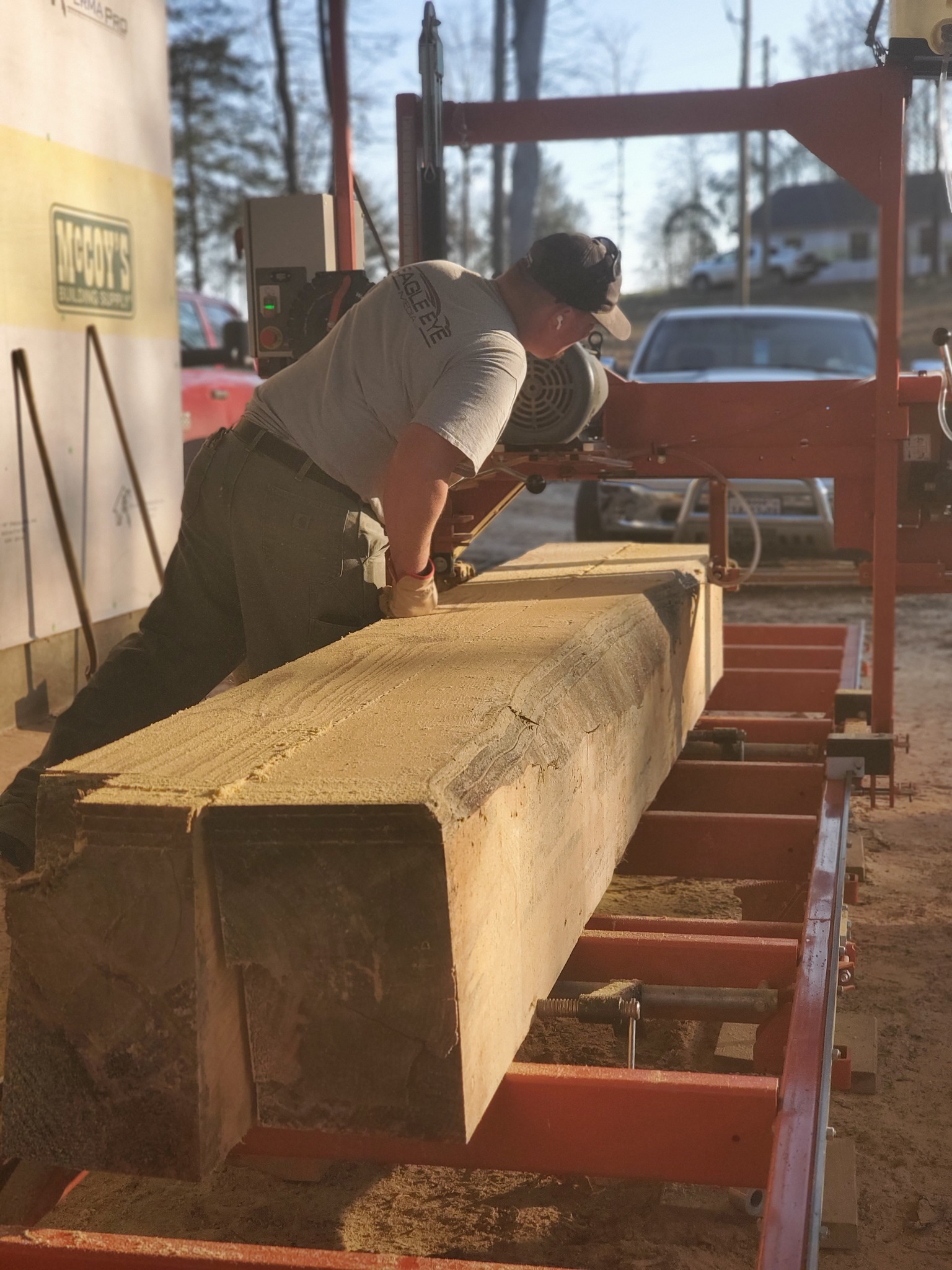 Owner Grant Wheeler overseeing the sawmill cutting a log