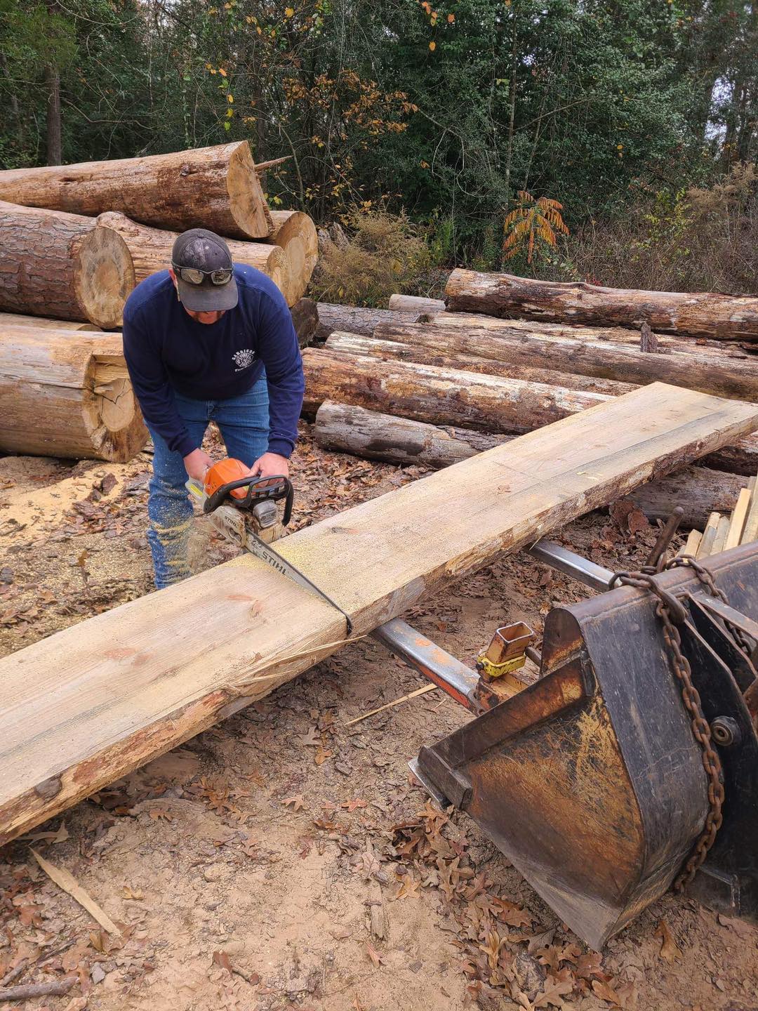 Owner Grant Wheeler using a chain saw 